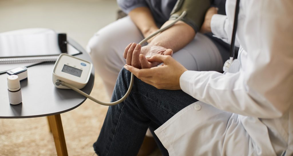 Female Doctor Checking Elder Patient